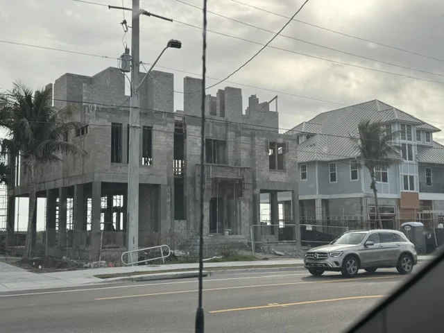 Elevated home under construction with a concrete block structure