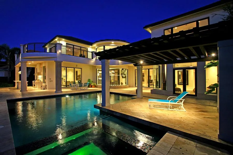 Lakefront pool patio night – Keene Point Residence by Kancor Companies, Orlando, FL