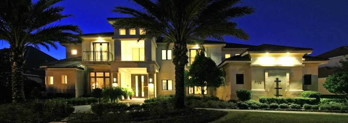 Front of a luxury custom home lit at night