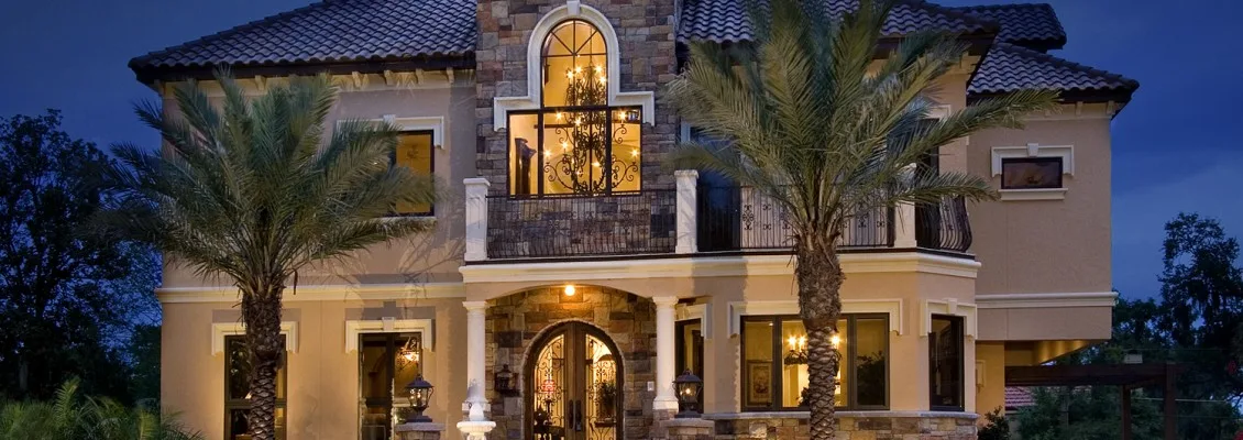 Mediterranean home exterior night – Seville Residence by Kancor Companies, Orlando, FL